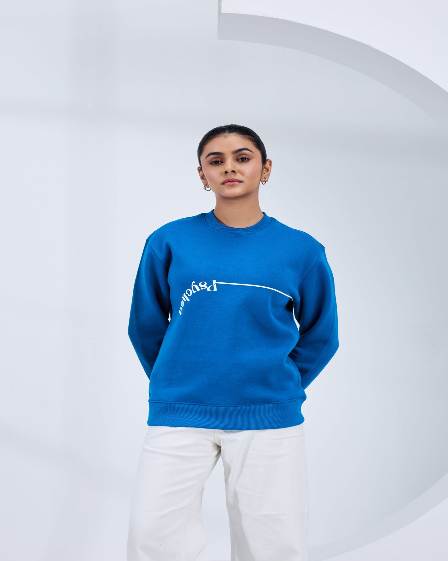 Person wearing a blue sweatshirt with white text on a white background