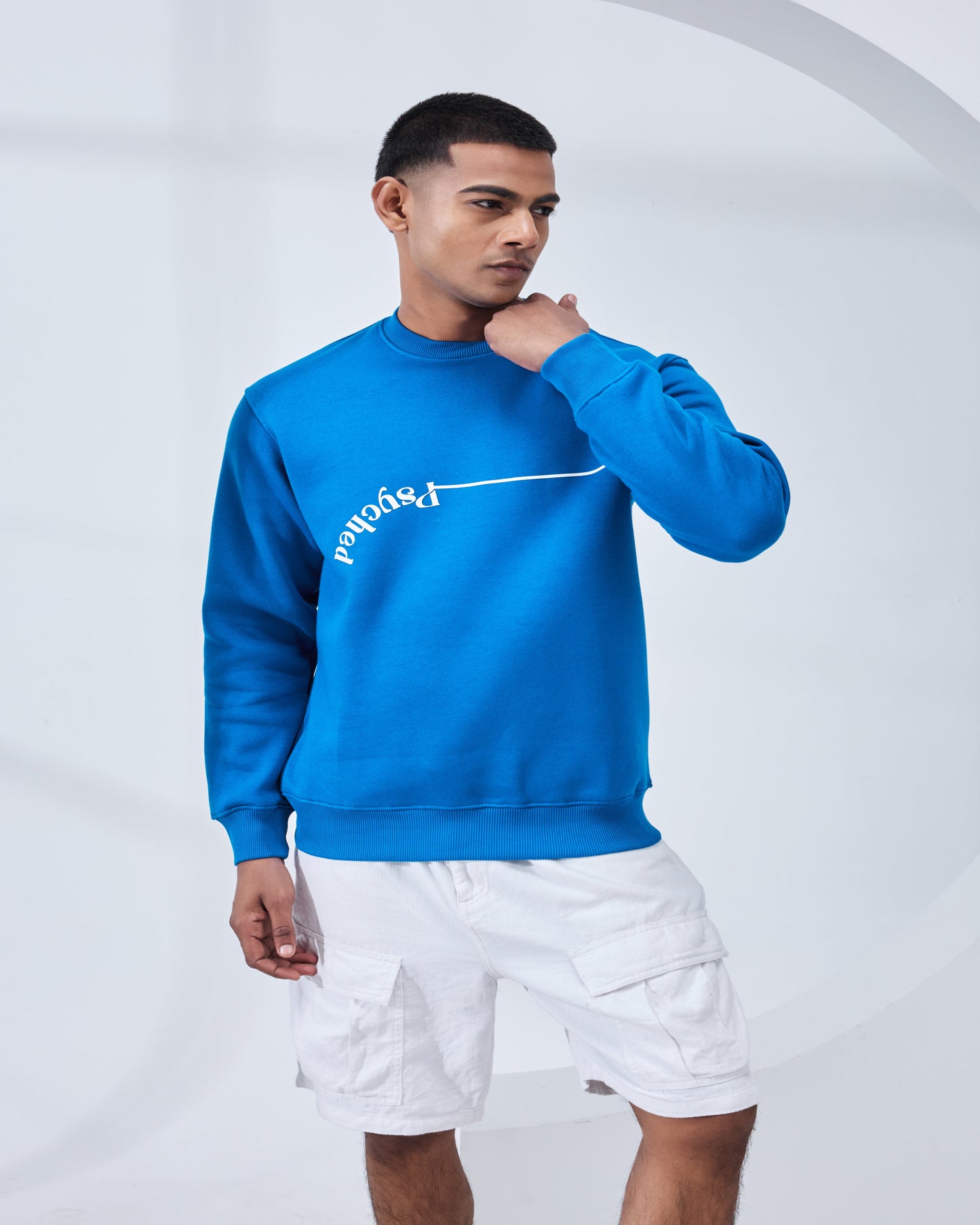 Man wearing a blue sweatshirt with white text on a white background