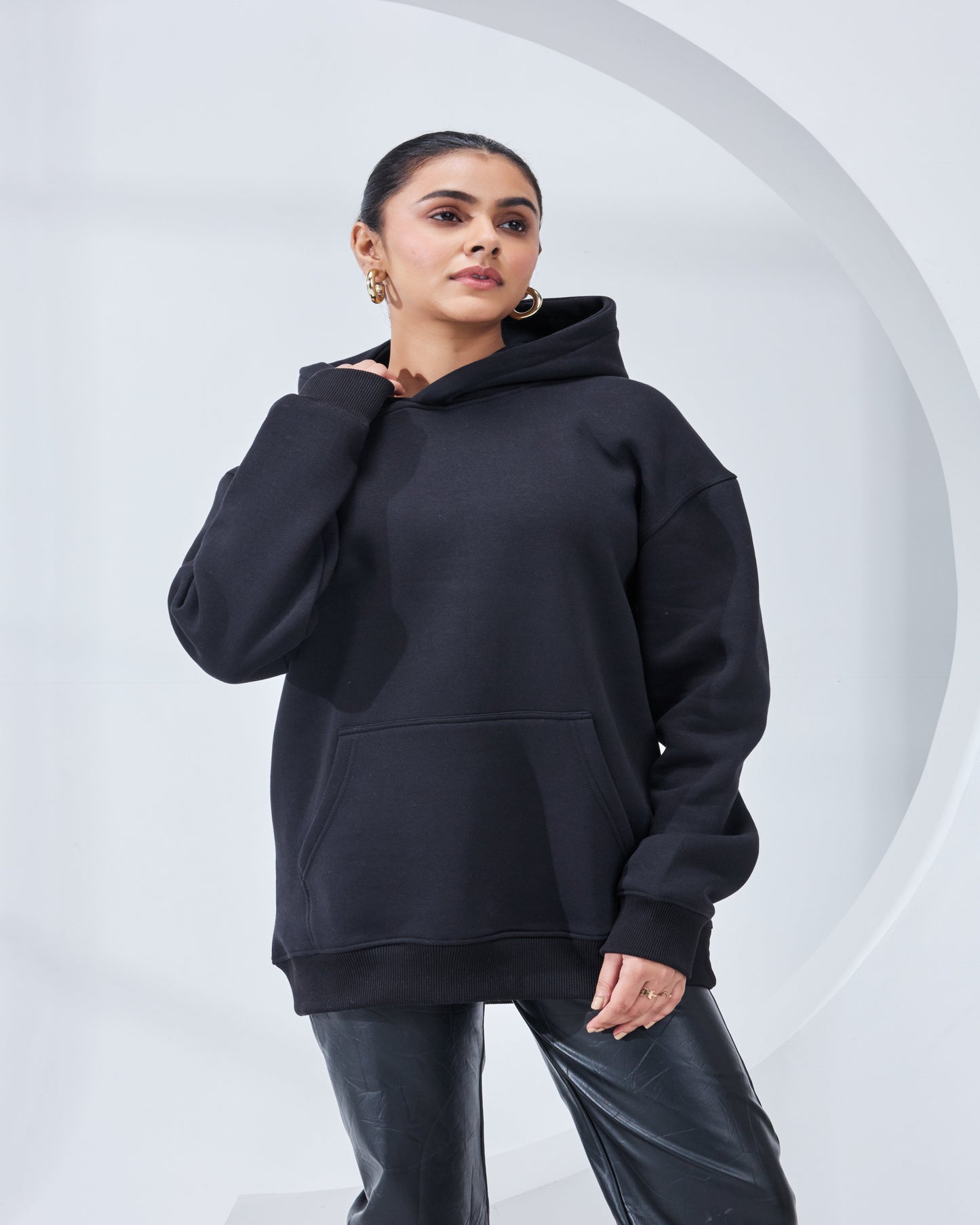 Person wearing a black hoodie against a white background