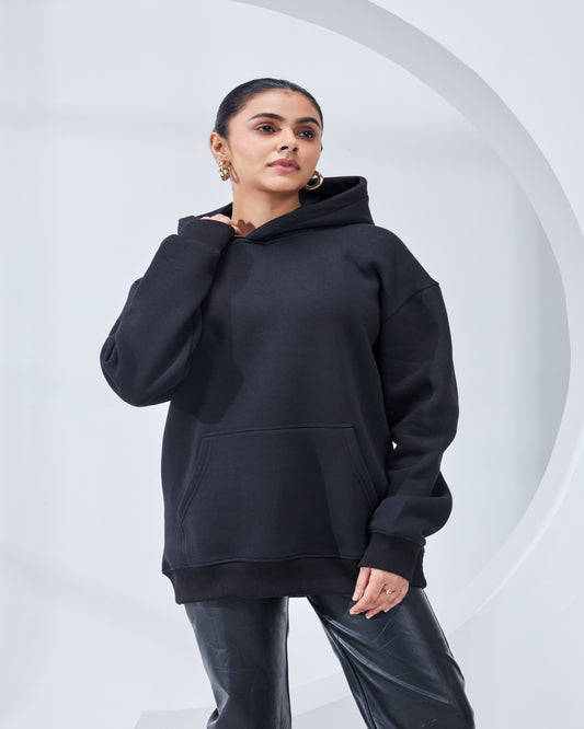 Person wearing a black hoodie against a white background